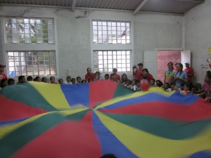 Kids playing with a parachute
